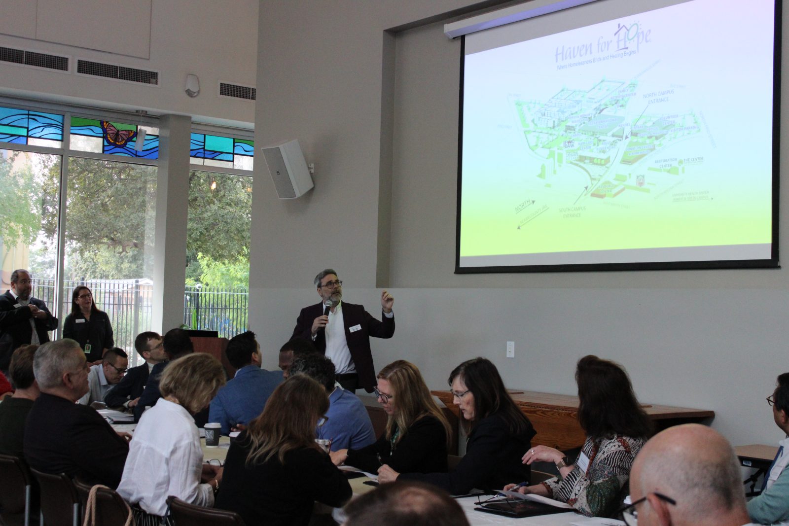 Beyond Homeless presentation with campus development plans projected on screen